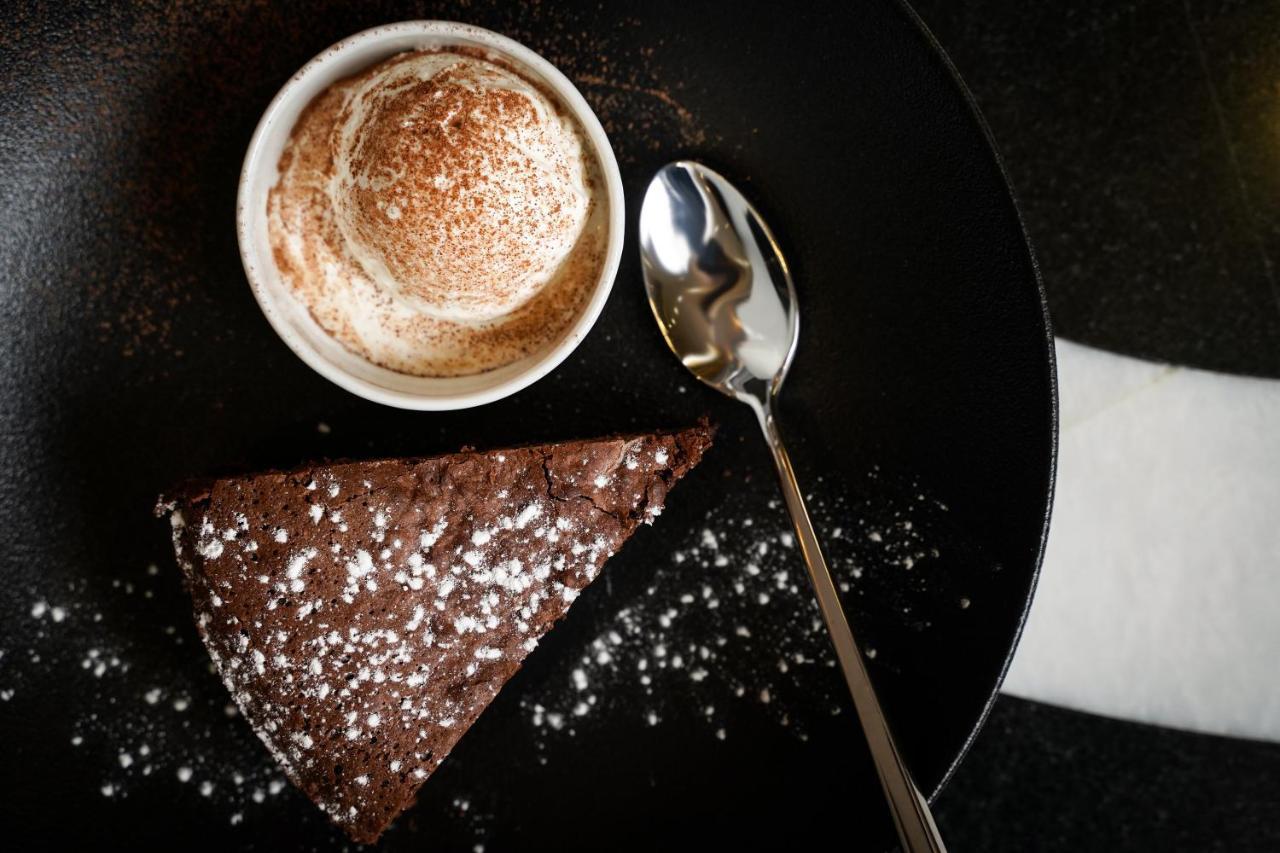 Ambiance Boutique Art Hotel Lahore Exterior foto A chocolate cake with a cup of coffee
